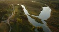 Winding river in the city park. City park at dawn. Aerial photography