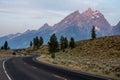 Winding Road Climbs Hillside in front of the Tetons Royalty Free Stock Photo