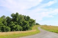 winding road through country hillside sunny trees Royalty Free Stock Photo