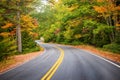 Winding road curves through autumn trees in New England Royalty Free Stock Photo