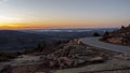 A winding road down a mountain during sunset Royalty Free Stock Photo