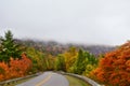 Winding road through foggy fall forest in Appalachian Mountain Royalty Free Stock Photo