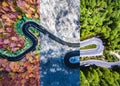 Winding road in the forest. Autumn, summer and winter time colage. Top down aerial view from a drone. Royalty Free Stock Photo