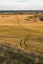 Winding road among green hilly fields in early spring Royalty Free Stock Photo