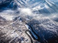 Winding road from the high mountain pass in Transylvania, Romania in the winter. Great road trip trough the dense woods. Aerial v Royalty Free Stock Photo