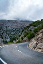 Winding road leading to the mountains of Majorca. Dramatic storm clouds over mountains Royalty Free Stock Photo