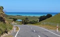 Winding road leads down to the sea in New Zealand