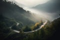 a winding road in the middle of a forest with fog Royalty Free Stock Photo