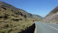 Winding road between mountains on a bright sunny day Royalty Free Stock Photo