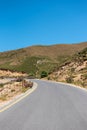A winding road through mountains on a sunny day. Royalty Free Stock Photo