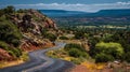 Winding Road Through Scenic Landscape with Cliffs and Distant Mountains Royalty Free Stock Photo