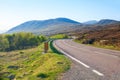 Winding road through the Scottish Highlands in the morning, United Kingdom. Typical Scottish mountain landscape in spring