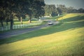 Winding road with white fence and live oak tree in Louisiana Royalty Free Stock Photo