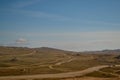 Winding roads in steppe among hills and mountains covered with green yellow grass. Baikal nature. Royalty Free Stock Photo