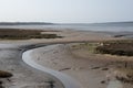 Winding Stream in muddy estuary low tide