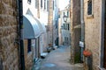 Winding street of the authentic, old town of Herceg Novi, Montenegro. We see old houses and very narrow