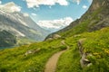 Winding walking trail high above the Oeschinensee lake