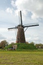 Windmill (back) in dutch landscape with clouds Royalty Free Stock Photo