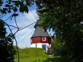 Windmill behind the trees Royalty Free Stock Photo