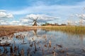 Windmill, blue sky and river