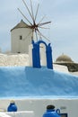 Windmill and blue wall on Santorini Island.