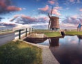 Windmill and bridge near the water canal at sunrise Royalty Free Stock Photo