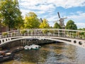 Windmill and bridge over canal in historic old town of Dokkum, F