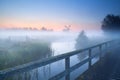 Windmill from bridge over river Royalty Free Stock Photo