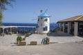 Windmill, Cape Skinari, Zakynthos - September 27, 2021: Beautiful traditional greece windmill on the rock up coastline