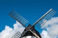 Windmill close up, with black sails and blue sky