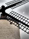 Windmill closeup with the sun in a grey sky Royalty Free Stock Photo