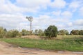 Windmill in a cloudy sky rural Australian landscape Royalty Free Stock Photo