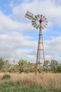 Windmill in a cloudy sky rural Australian landscape Royalty Free Stock Photo