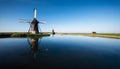 windmill in the country reflected in the water Royalty Free Stock Photo