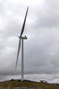 Windmill on dark cloudy sky