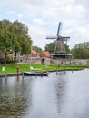 Windmill de Kaai and canal with sailboat in city of Sloten, Sleat, Friesland, Netherlands Royalty Free Stock Photo