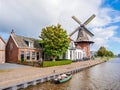 Windmill De Zwaluw and Dokkumer Ee canal in  Burdaard in Friesland, Netherlands Royalty Free Stock Photo