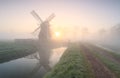 Windmill in dense fog at sunrise Royalty Free Stock Photo