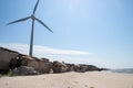 Windmill for electricity generation and ruins of the sea fort in Liepaja