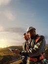 Windmill engineer and businessman planing new ecology project. they standing and looking in tablet. Around wind generators