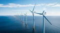 Windmill farm in the ocean. Offshore wind turbines in the sea. Ocean Wind Farm. Royalty Free Stock Photo