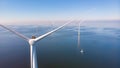 Huge windmill turbines, Offshore Windmill farm in the ocean Westermeerwind park , windmills isolated at sea on a Royalty Free Stock Photo