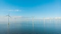 Huge windmill turbines, Offshore Windmill farm in the ocean Westermeerwind park , windmills isolated at sea on a Royalty Free Stock Photo