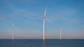 Huge windmill turbines, Offshore Windmill farm in the ocean Westermeerwind park , windmills isolated at sea on a Royalty Free Stock Photo