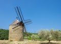 Windmill on a field in Provence, among olive trees Royalty Free Stock Photo