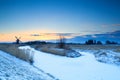 Windmill by frozen river at sunrise, Groningen