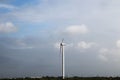 windmill generates electricity green trees and white clouds natural scenery