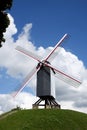 Windmill on a grass hill Royalty Free Stock Photo