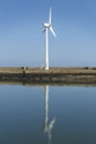 Windmill on a Harbour wall, generating electrisity Royalty Free Stock Photo