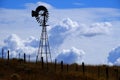 Windmill on Hillside in Countryside Rural America with Sky and Clouds